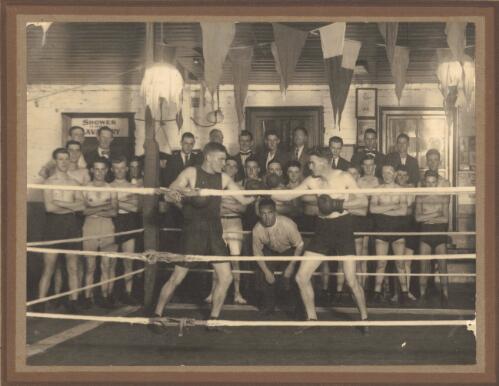 [Herb McCoy, at left, sparring in a Fitzroy gymasium watched by boxers] [picture]