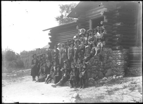 Exterior of Girl Guides hall; group photo of women and girls; some in Girl Guides uniform and some in school uniform, Eden, ca. 1936 [picture]