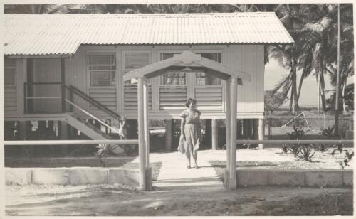 Isabelle Bunker outside her home in the Qantas Staff Married Quarters on West Island, Cocos Islands, between 1952 and 1954 [picture] / Tom Meigan