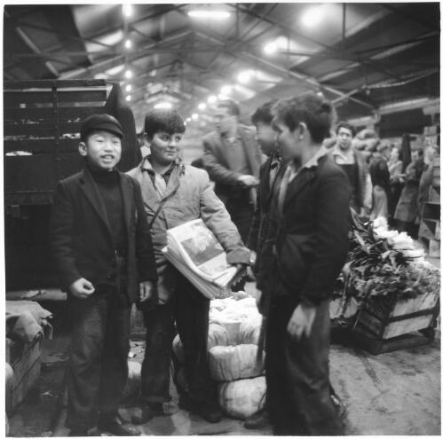 Ken Wong standing with paper boy George Debrincat, Queen Victoria Markets, June 1961 [picture] / Jeff Carter