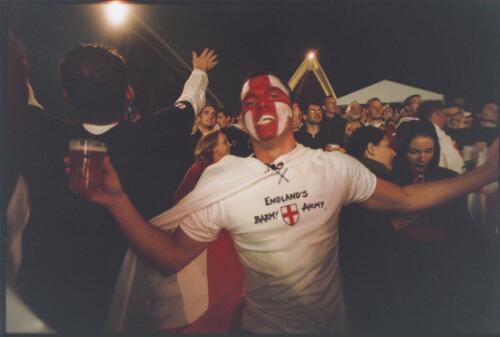 English supporter wearing a Barmy Army T-shirt on the steps of the Sydney Opera House during the live telecast of the Rugby World Cup final, Sydney, November 2003 [picture] / Ben Rushton
