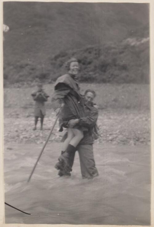 "Fording part of the Waiho Gorge", [Paul carries Myrtle Maclagan across a flooded river] New Zealand, 1935 [picture]