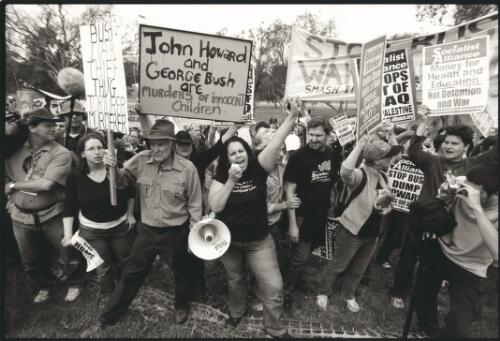 Protest group break through the barricade around the United States Embassy in Canberra where President George W. Bush is a guest, 23 October, 2003 [picture] / Ben Rushton