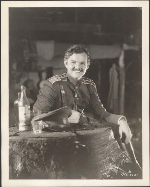 [Lawrence Tibbett as Lieutenant Michael Petroff, seated at a table, for the film, New moon, 1930?] [picture]