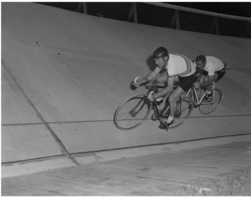 Two cyclists, one of whom is Australian?, racing at the velodrome, Olympic Games, Swan Street, Melbourne, 4 December 1956 [picture]