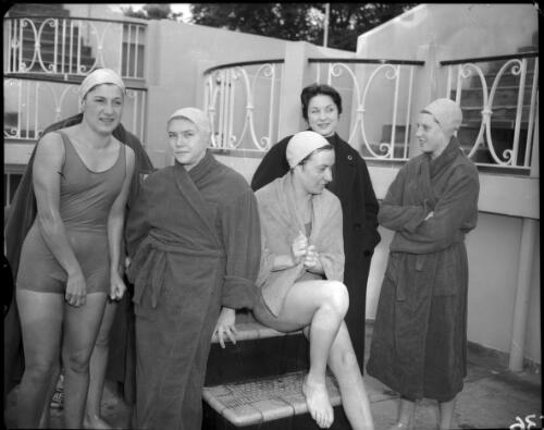 French swimmers taking a break from training at the old Olympic pool in Batman Avenue: (from left) Ginette Sendral, Odile Vouaup, Heda Frost, Colette Thomas, Madame Boileau (manageress) and Vivane Gouderneur, [Olympic Games, Melbourne, 27 November 1956] [picture]