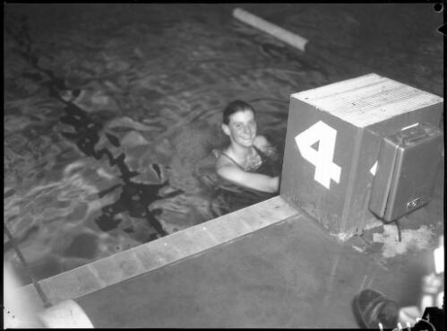 [Unidentified female swimmer in the water by starting block 4, Olympic Games, Melbourne, 29 November 1956] [picture]
