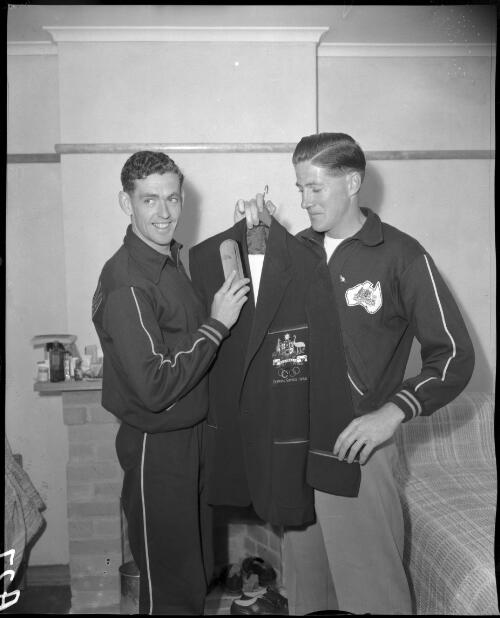 [Two Australian male athletes brushing a jacket, Olympic Games, Melbourne, 22 November 1956] [picture]