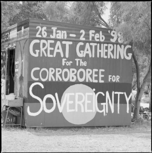 Aboriginal Tent Embassy with Aboriginal flag and a sign about the Sovereignty gathering painted on the exterior, Canberra, 30 January 1998 [picture] / Loui Seselja