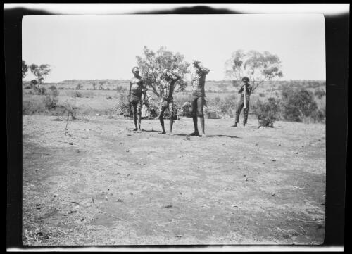 Three Aboriginal dancers and a didgeridoo player, wearing body paint, Wave Hill Station, Northern Territory, 1925 / Michael Terry