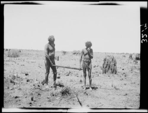 A blind Aboriginal Australian man being led by his wife using a wooden pole, Western Australia, 1925 / Michael Terry