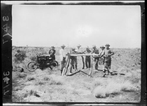 Aboriginal Australian stockmen and members of the expedition standing around Sullivan's grave, Mindibungu, Western Australia, 1925 / Michael Terry