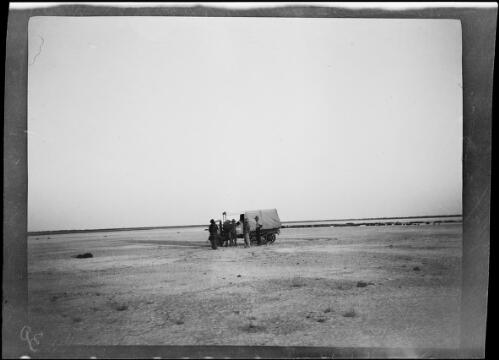 Expedition members standing next to a Guy roadless truck, nicknamed Maililma, on the dry bed of Lake Gregory, Western Australia, 1925 / Michael Terry