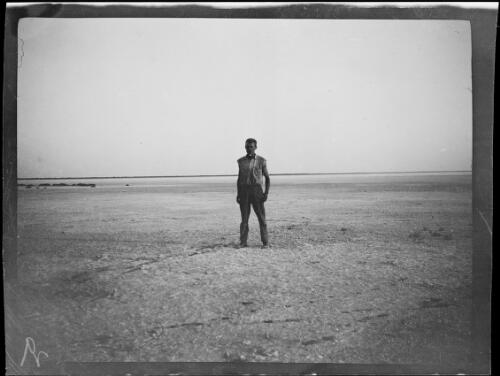 Expedition member standing on the salt deposit of Lake Gregory, Western Australia, 1925 / Michael Terry