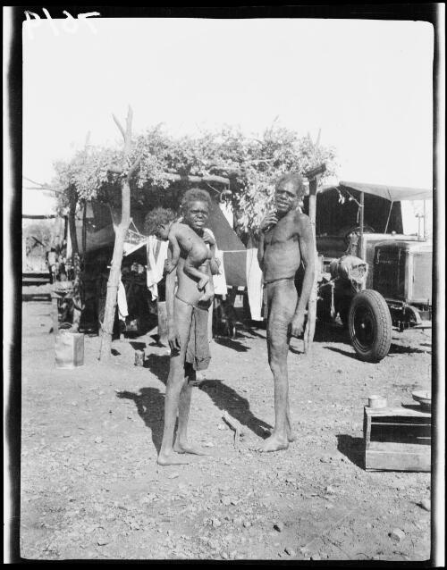 Aboriginal family, man, woman and baby at the expedition's camp site, Ivy Leases, Tanami Desert, Northern Territory, 1928 / Michael Terry