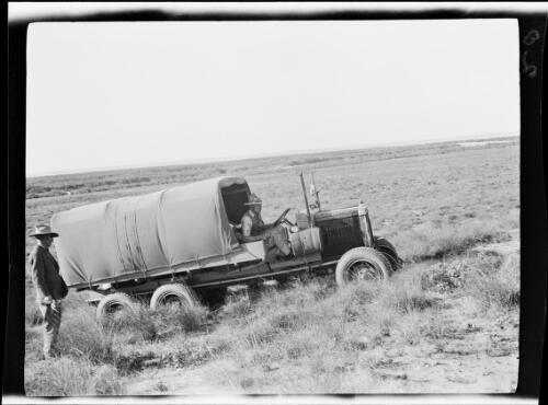 Michael Terry driving one of the expedition vehicles up a hill, Pardoo Station, Western Australia, 1928, 1 / Michael Terry