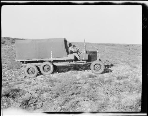 Michael Terry driving one of the expedition vehicles up a hill, Pardoo Station, Western Australia, 1928, 2 / Michael Terry