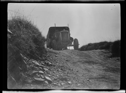 The expedition's Morris Commercial truck approaching the crest on a dirt road, Halls Creek Region, Western Australia, 1928 / Michael Terry