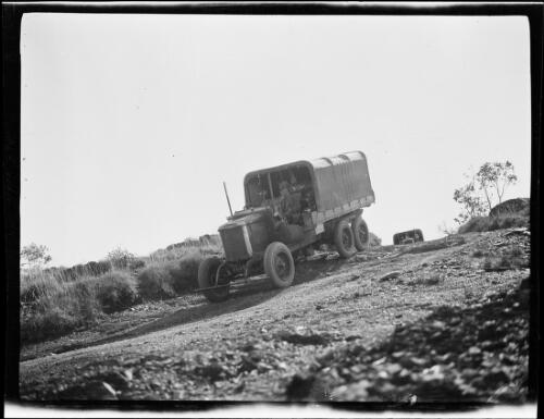 The expedition's Morris Commercial trucks descending on a dirt road, Halls Creek Region, Western Australia, 1928 / Michael Terry
