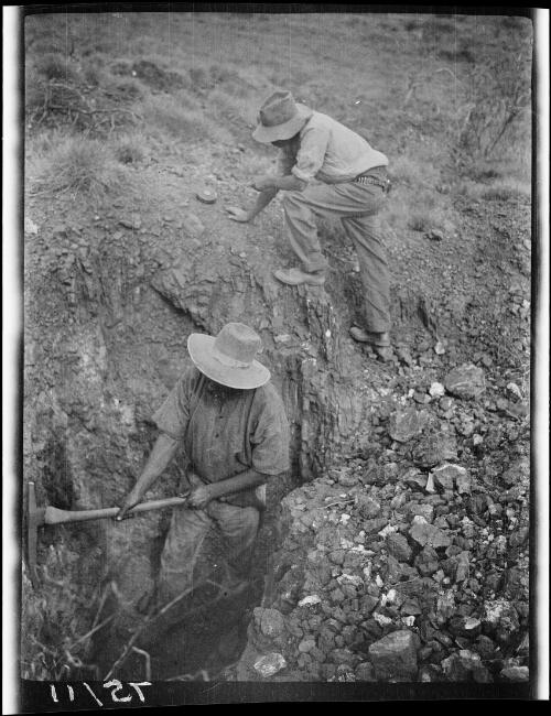 Two expedition members checking the soil composition near Tanami, Northern Territory, 1928 / Michael Terry
