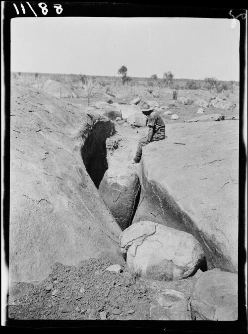 Expedition member Keyser sitting on top of Thomsons Rockhole, Northern Territory, 1928 / Michael Terry