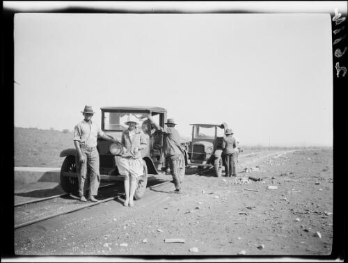 Four men, a woman and two trucks on a railway track, Central Australia?, approximately 1929 / Michael Terry