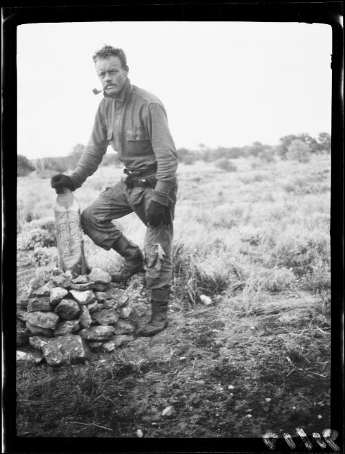 Michael Terry and a 55 mile pastoral boundary marker, Warburton Range, Western Australia, 1931