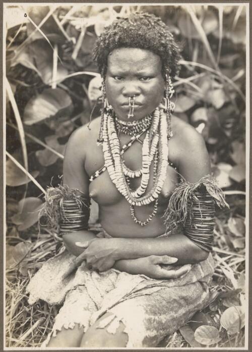 Ambasi types [seated girl wearing necklaces and armbands] [picture] / Frank Hurley