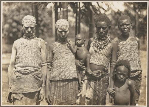 Ambasi villages, North Coast [four women (two in mourning and covered in clay) with two children] [picture] / Frank Hurley