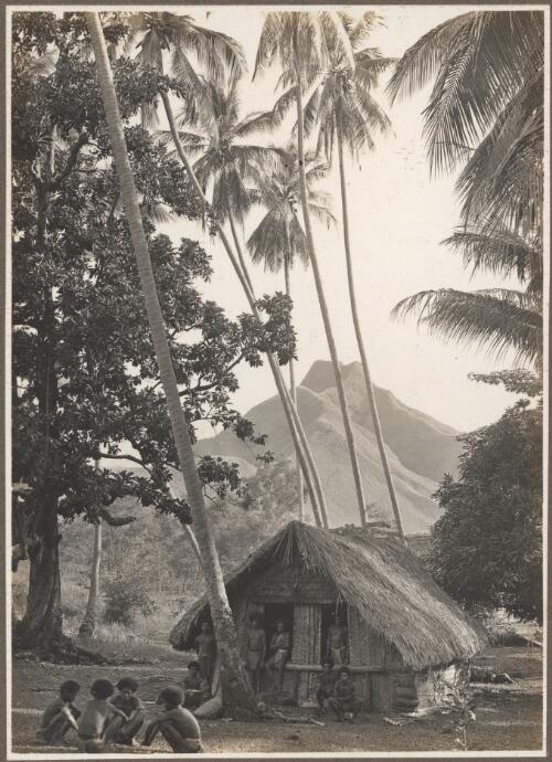 Scenes at Boianai [hut with a group of men sitting and standing outside] [picture] / Frank Hurley