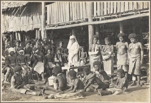 Glimpses around Wanigella [Wanigela], [nurse and a group of people wearing bandages] [picture] / Frank Hurley