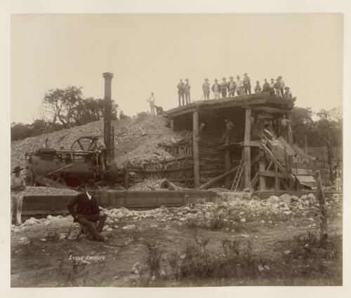 A group of men standing around a stone crusher [picture] / Ryan & Thompson