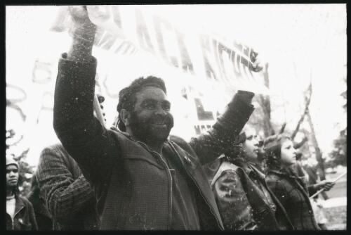 [Unidentified Aboriginal male protestor holding 'Down with whites who refuse black rights' banner at land rights demonstration, Parliament House, Canberra, 30 July 1972, 2] [picture] / Ken Middleton