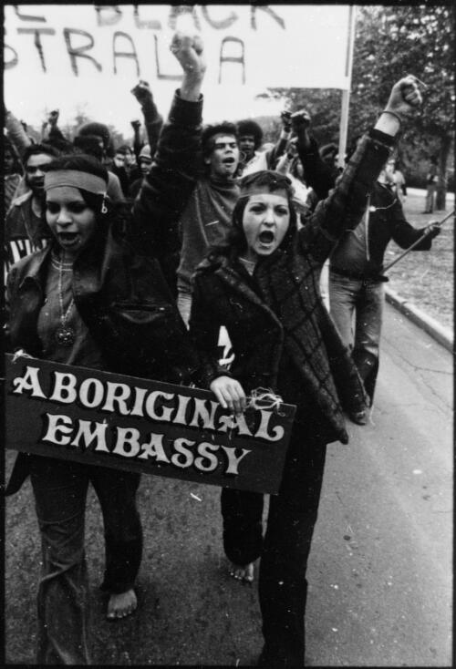 Two unidentified women marching with a banner at the Aboriginal land rights demonstration, Parliament House, Canberra, 30 July 1972 [picture] / Ken Middleton