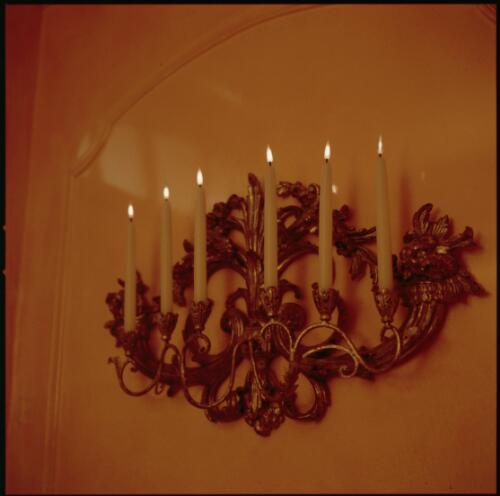 [Electric candles in a carved and gilded wall sconce, ca. 1971] [transparency] / David Beal