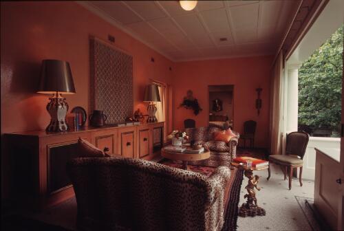 [Garden room with animal skin fabric settees and tangerine stippled walls and fitment, ca. 1971] [transparency] / David Beal