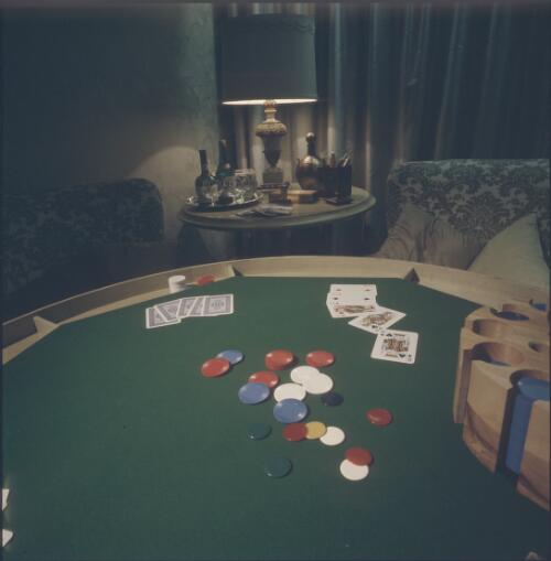 [Custom-made green baize poker table with a side table and lamp behind, ca. 1971] [transparency] / David Beal