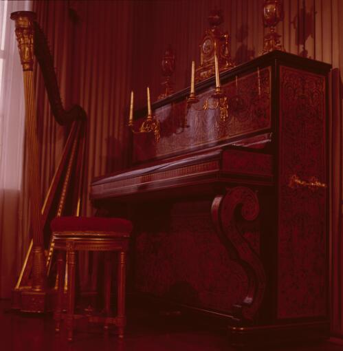 [An intricately decorated piano, harp and a red piano stool, ca. 1971] [transparency] / David Beal