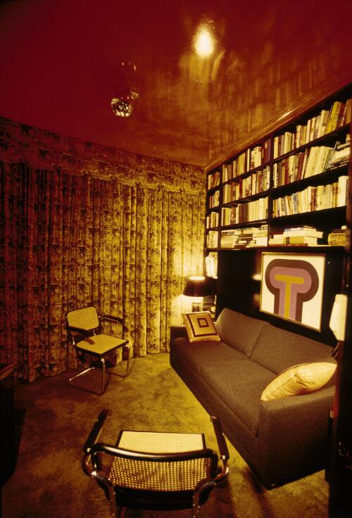 [Library with a wall of books and shiny red ceiling above a deep black sofa and two chairs, ca. 1971] [transparency] / David Beal