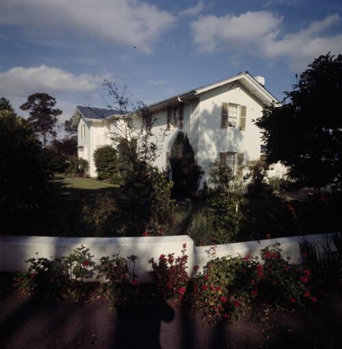 [View of a two-storeyed white house and its garden, with the garden wall in the foreground, ca. 1971] [transparency] / David Beal