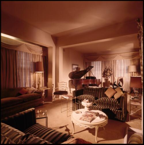 [Sitting room with paper silk draperies and shadow-striped velvet settees with an adjoining music annexe contaning a Steinway grand piano, ca. 1971] [transparency] / David Beal