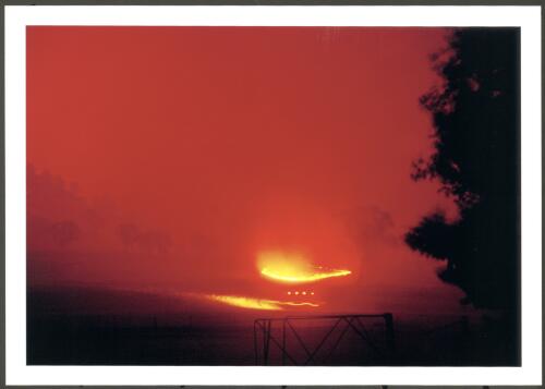 A light bushfire tanker (flashing red lights) approaching a spot fire on Congwarra thrown from the Bendora fire in the pre-dawn of 18th January 2003 [picture] / Jeff Cutting