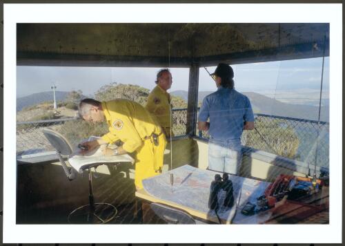 The lookout operator on Mount Coree discussing with National Park rangers the location of fires and weather in the Brindabella Mountains, 8th January 2003 [picture] / Jeff Cutting