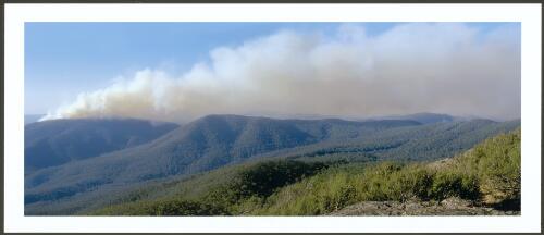 The languid smoke plume of the McIntyres Hut fire burning on the crest of Webbs Ridge, with smoke (far right) from a spot fire on Baldy Range, [8 January 2003] [picture] / Jeff Cutting