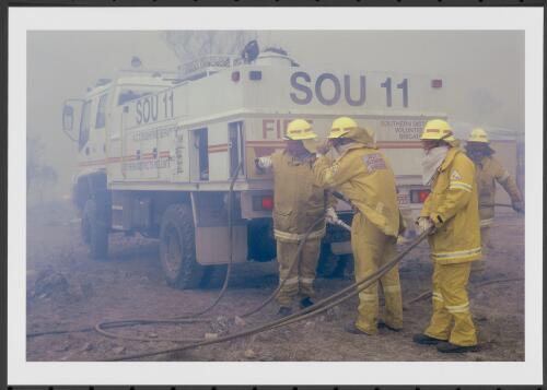 Repaired and regrouped, firefighters from ACT Southern Brigade prepare for another foray into the gritty smoke and scorching wind to protect a rural property on Clearview Range, Michelago, [30 January 2003] [picture] / Jeff Cutting