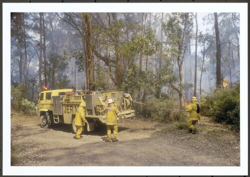 Firefighters from ACT Jerrabomberra Brigade preparing for a direct attack with water on a spot-over along Moonlight Hollow Road on Bendora Hill, [11 January 2003] [picture] / Jeff Cutting