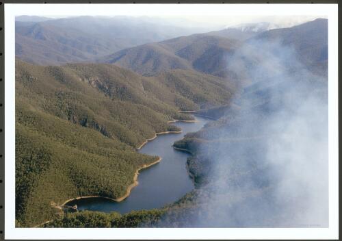 The Bendora Dam looking south up the Cotter Valley towards the Stockyard Spur and Mt Gingera fires, [13 January 2003] [picture] / Jeff Cutting