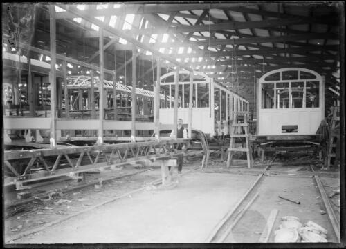 Interior view of a tram or railway workshop building carriages [picture] / C.C. Fox