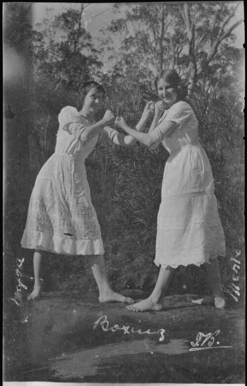 Two girls in petticoats posing as boxers [picture] / C.C. Fox