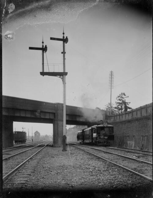 Motor rail passing under road bridge [picture] / C.C. Fox
